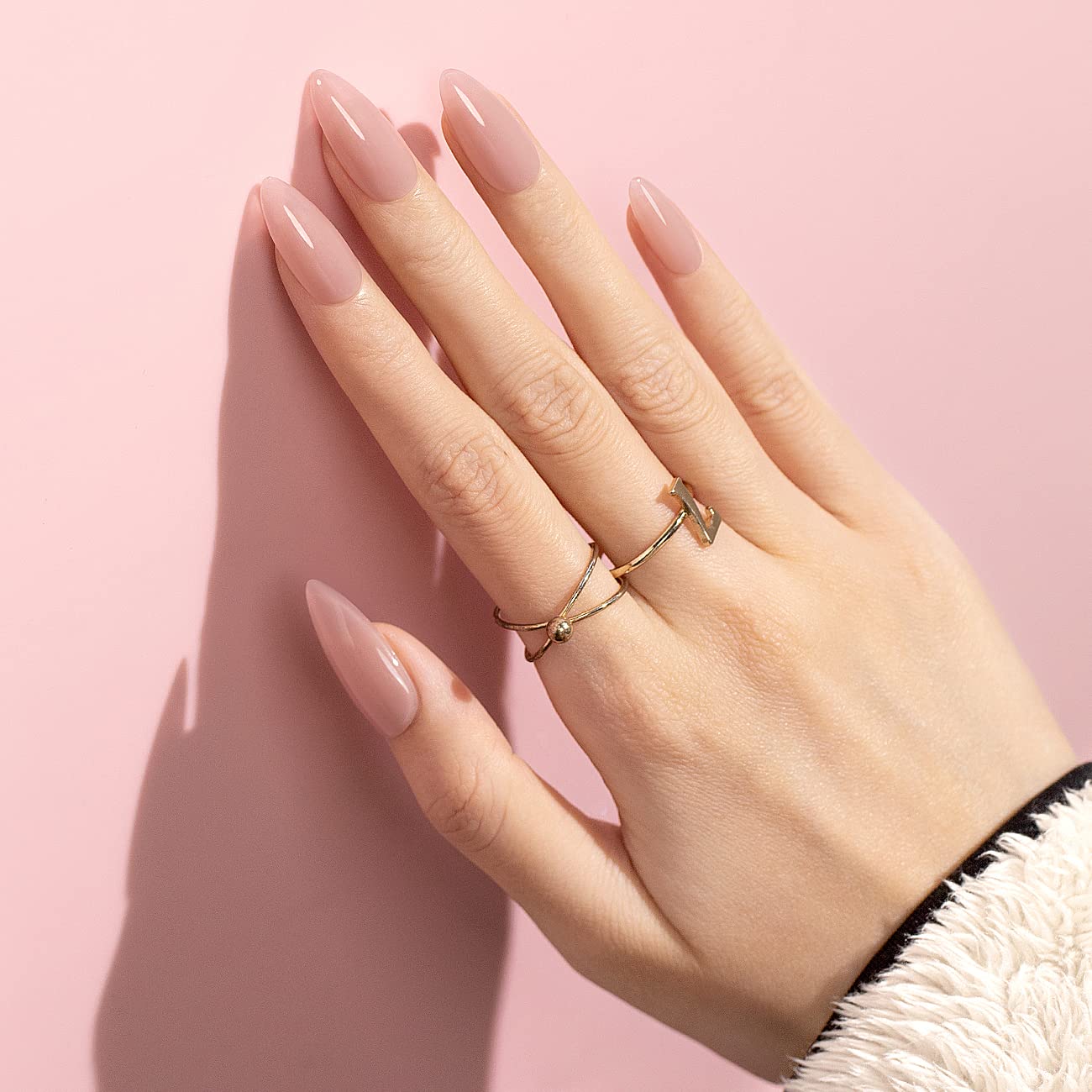 Petal Veil rose nude manicure high-gloss shine natural elegant look on almond nails with gold rings
