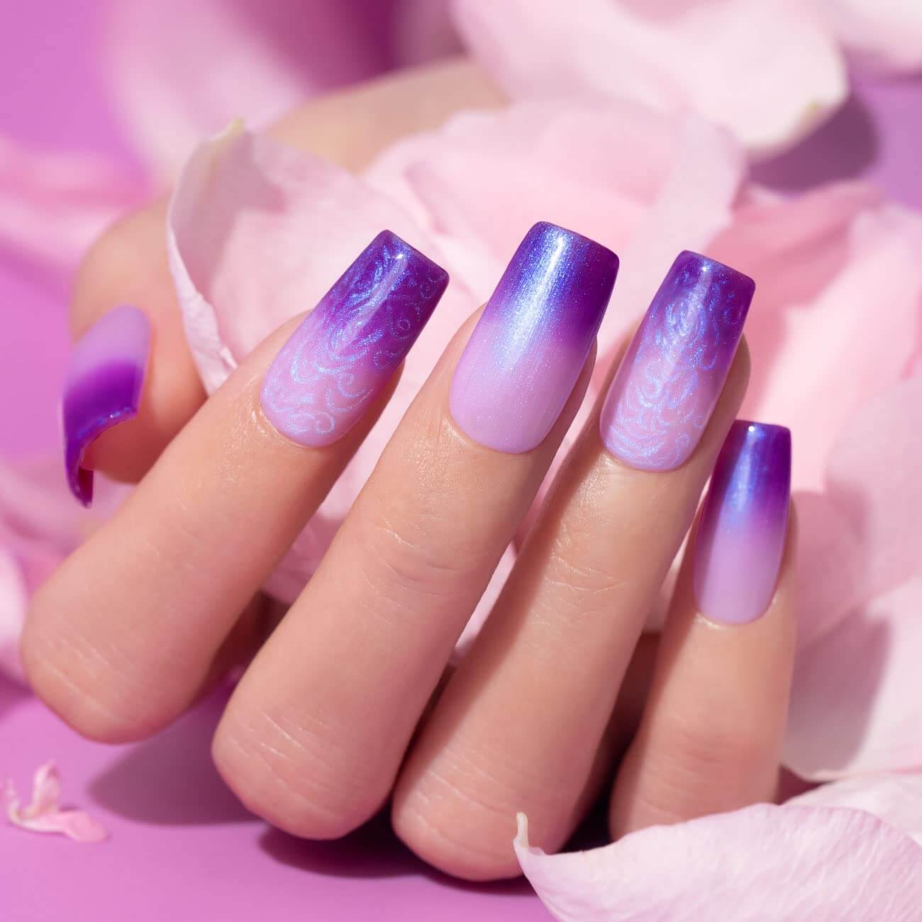 Blue purple temperature changing manicure long coffin nails pearl shell thread shimmer effect on hand with flowers
