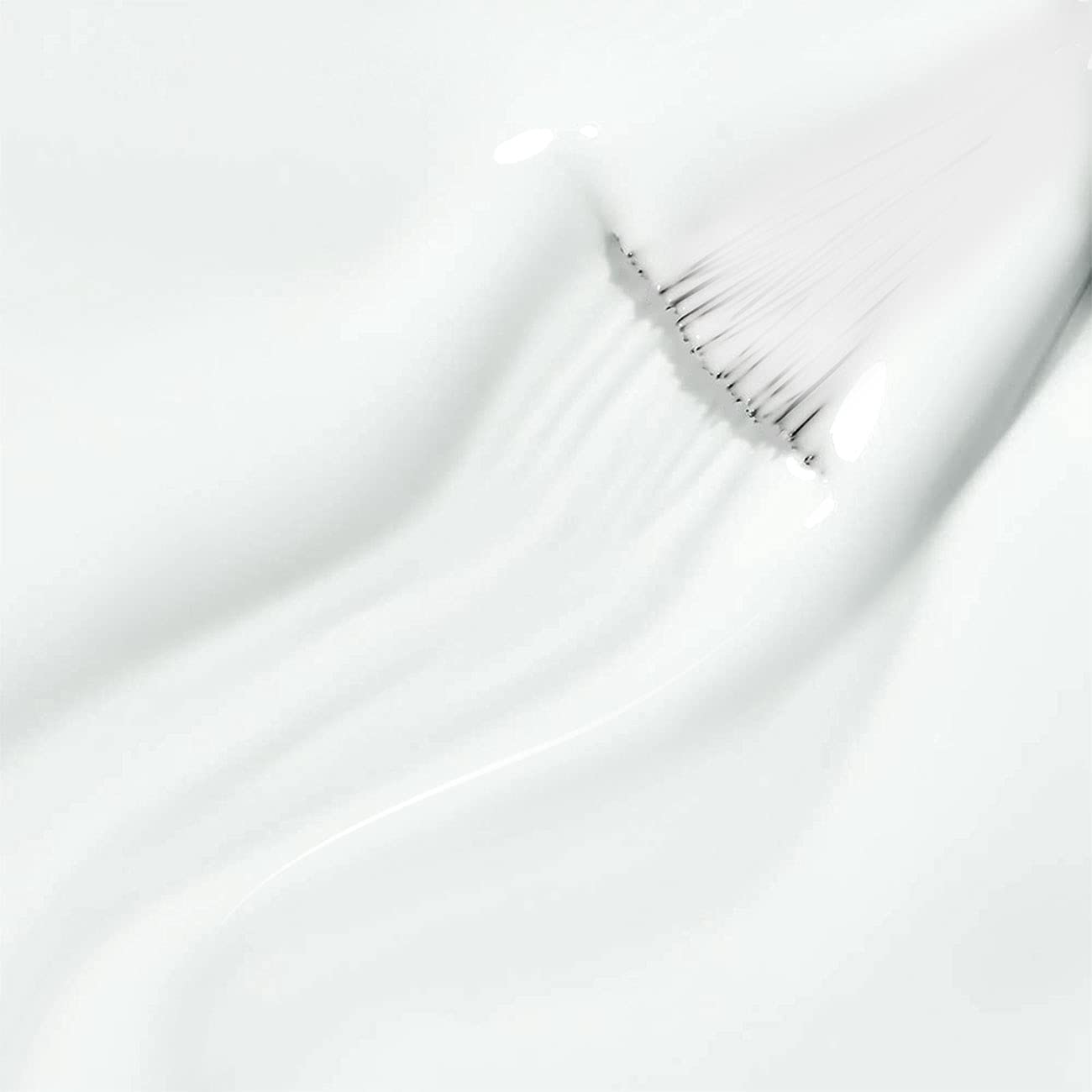 Pure white gel texture smooth self-leveling creamy formula ultra-pigmented close-up with brush
