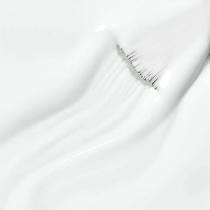 Pure white gel texture smooth self-leveling creamy formula ultra-pigmented close-up with brush
