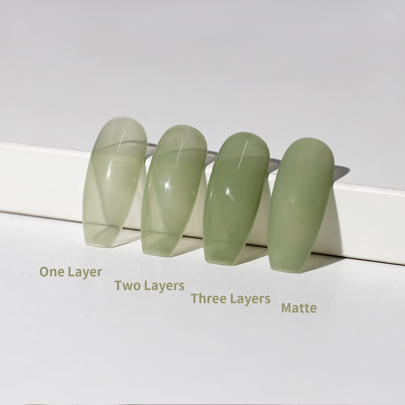 Different layers effect comparison 1 layer 2 layers 3 layers matte finish sheer sage green jelly buildable opacity on nail tips
